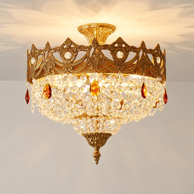 Close up of ornate antique gold metal frame with carved floral details and crystal accents