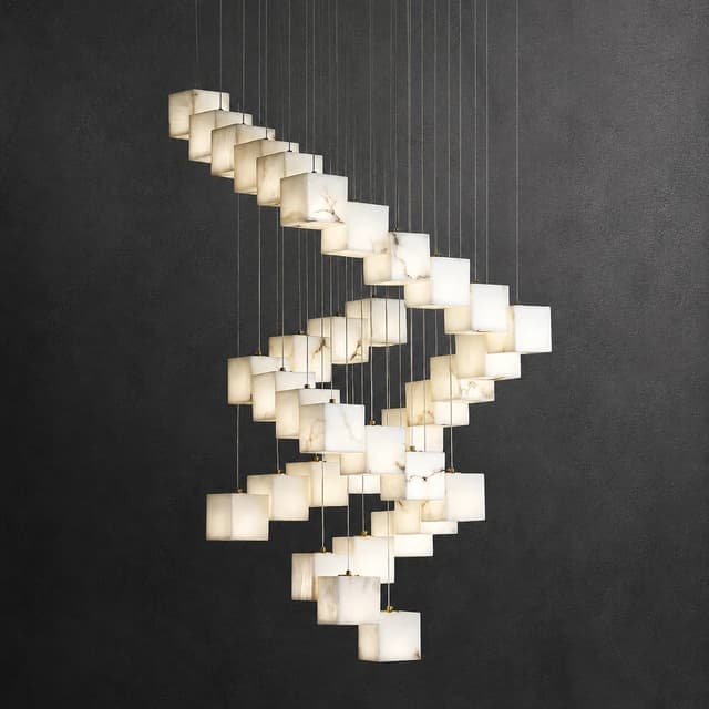 Large marble cube staircase chandelier creating a sculptural cascade in a double height foyer