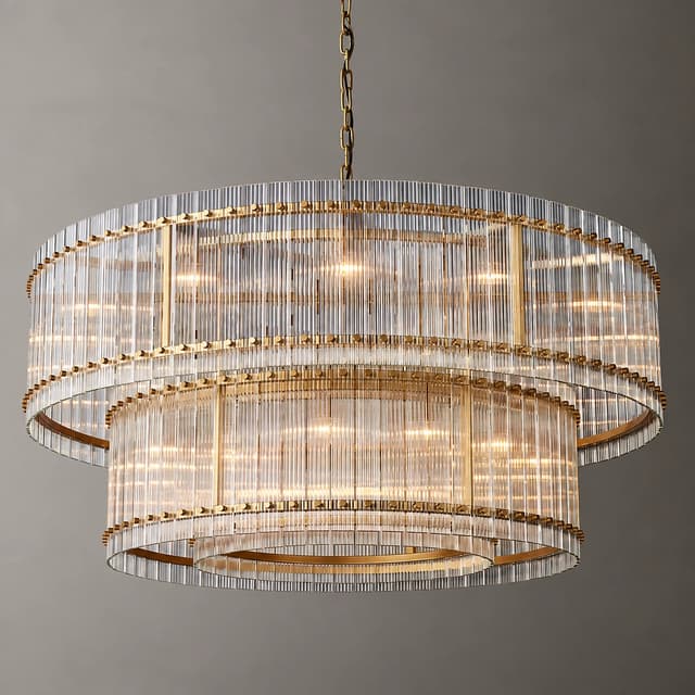 A large, two tier, transparent, crystal style circular chandelier featuring electroplated copper colored metal rings and warm lighting