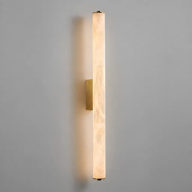 Illuminated brass vertical wall sconce with translucent marble veined cylinder diffuser