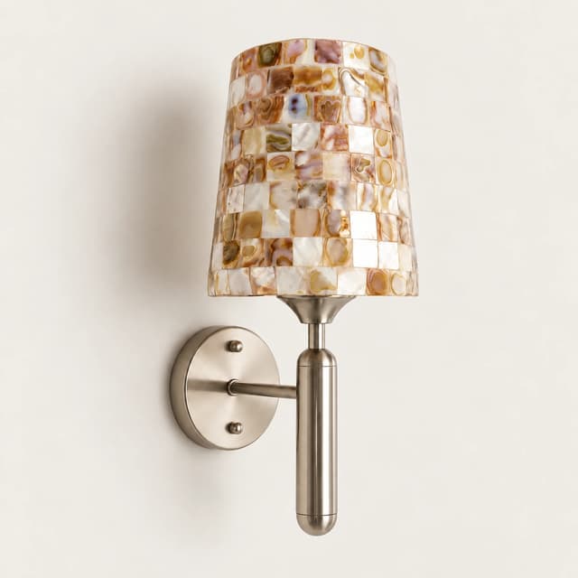 Mother of pearl mosaic wall sconce with brushed nickel finish in a warm modern interior