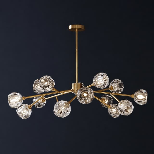 Large gold branch chandelier with multiple faceted clear globe shades on a dark background