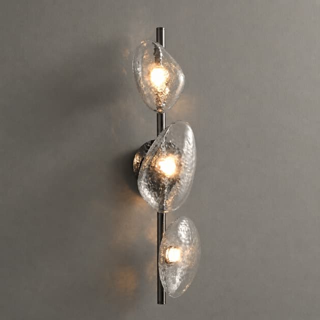 Three light clear textured glass wall sconce with organic pebble shades and warm illumination