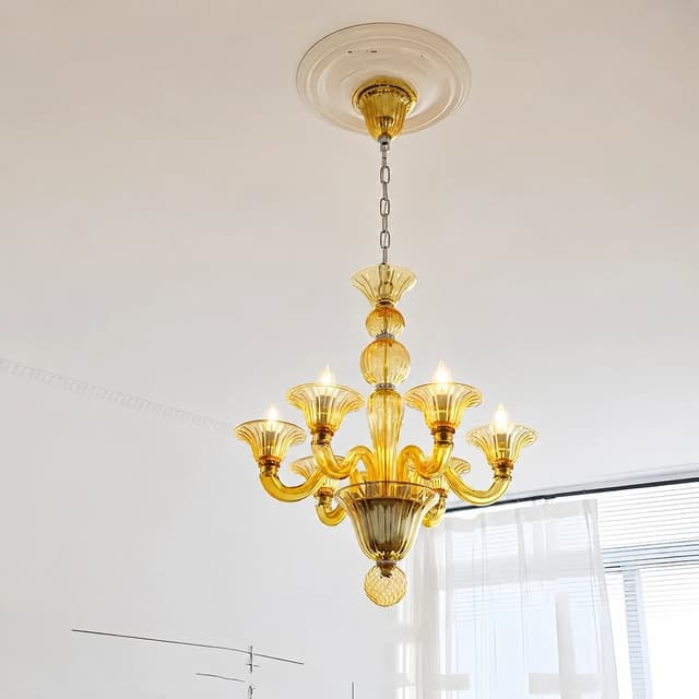 Amber colored glass chandelier with curved arms and chain suspension