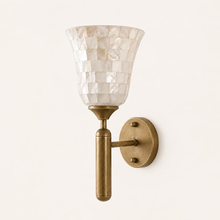 Close up of antique brass wall sconce hardware with pearlescent natural shell mosaic shade