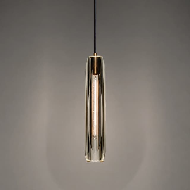 Slim clear crystal pendant light with warm copper frame and elongated sculptural design