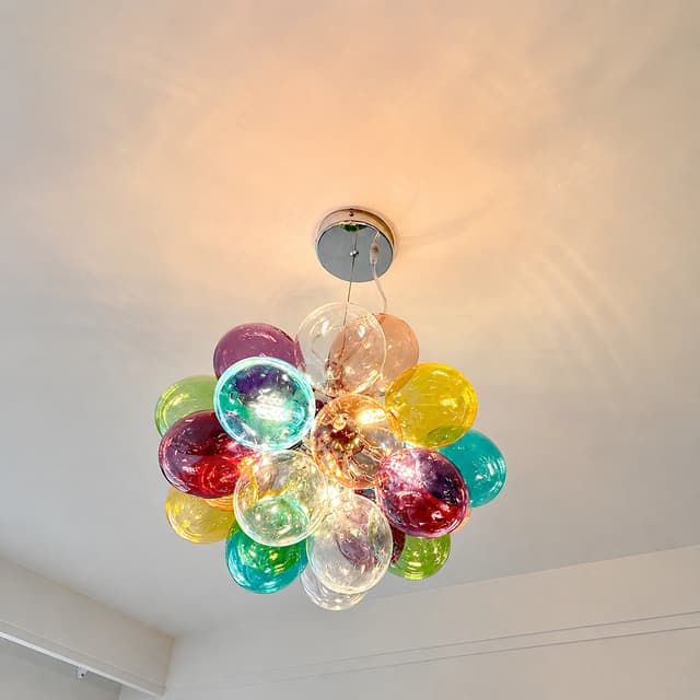 Upward installation view of colorful bubble chandelier with transparent multicolor globes