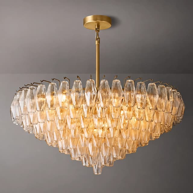 Illuminated tiered amber glass waterfall chandelier with gold tone canopy and cascading