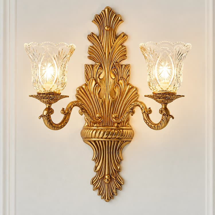 Traditional antique gold two light wall sconce with sculptural leaf backplate and decorative glass shades