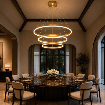 Large gold circular LED chandelier installed above a marble dining table in a luxury dining room