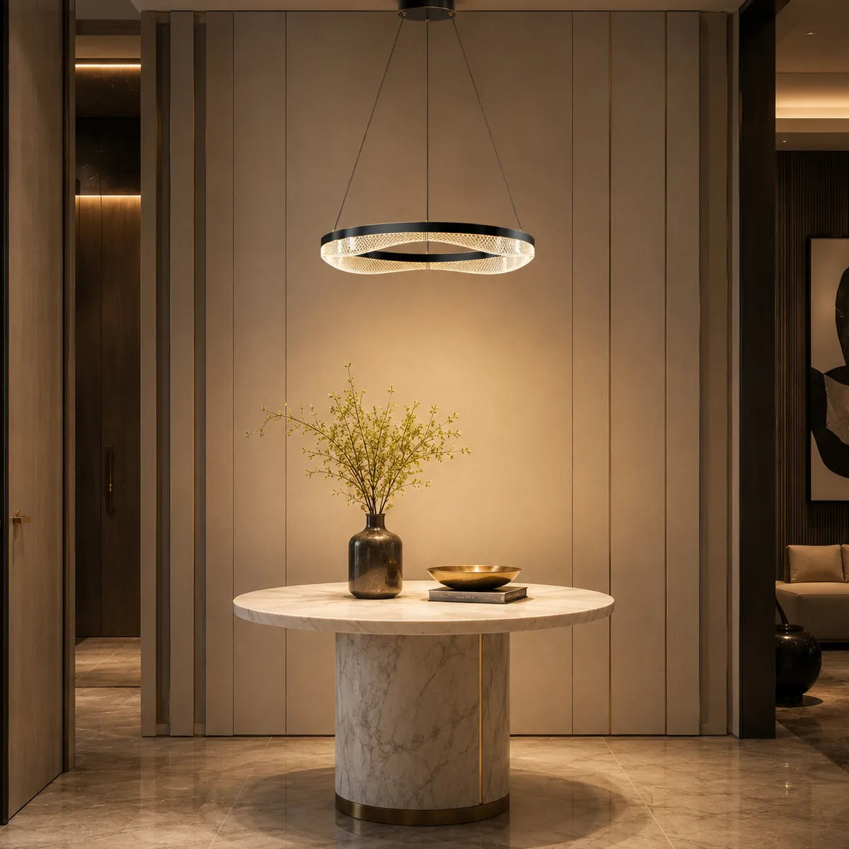 Black gold ring chandelier lighting a modern foyer table