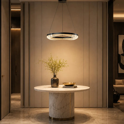 Black gold ring chandelier lighting a modern foyer table