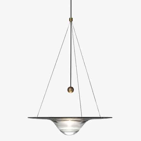 Front view of clear glass saucer pendant light with central illuminated lens, brass accent and fine suspension wires