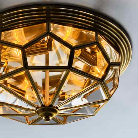 Tiffany style semi flush ceiling light with textured amber glass, bronze framing and warm decorative illumination