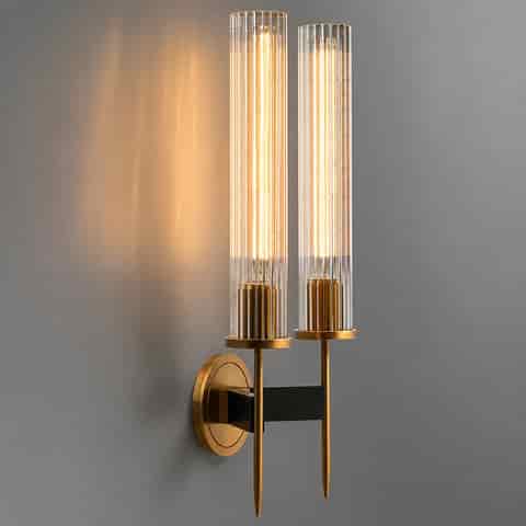 Two light clear fluted glass wall sconce with copper frame and warm glow