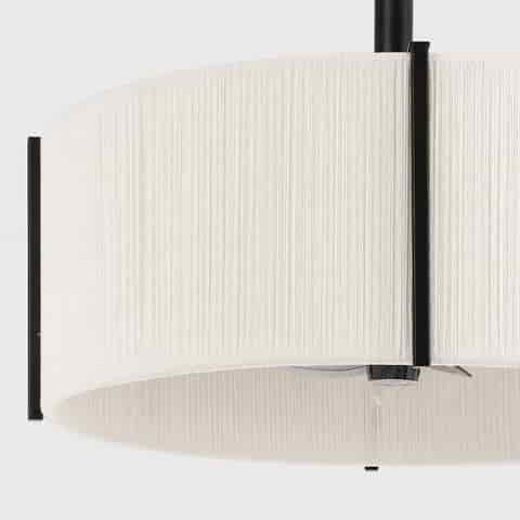 Close up of cream white textured fabric drum shade with black metal frame