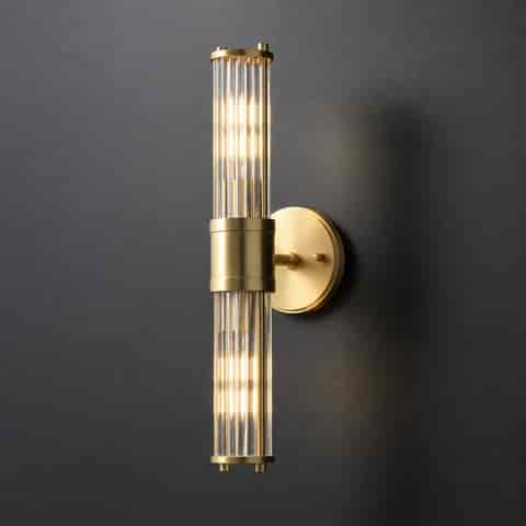 18 inch double ended brass finish glass rod wall sconce on a dark textured wall