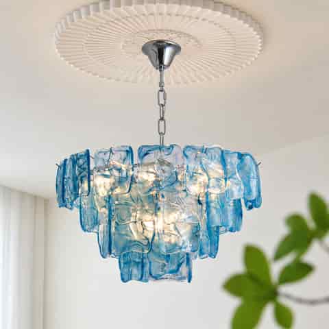 Blue artistic glass chandelier with layered glass panels in an elegant interior