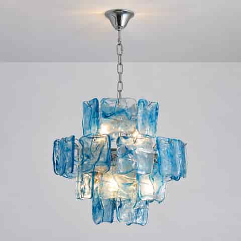 Blue glass chandelier shown without illumination, highlighting the layered glass arrangement