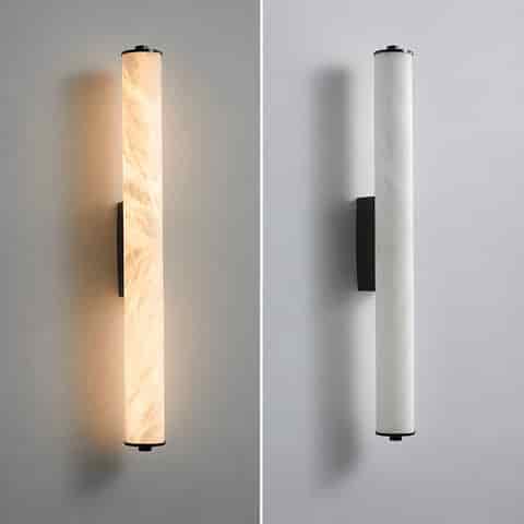 Black vertical cylinder wall sconce shown in illuminated and unlit views
