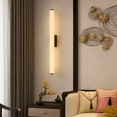 Tall alabaster style wall light with brass accents in an elegant Asian inspired interior