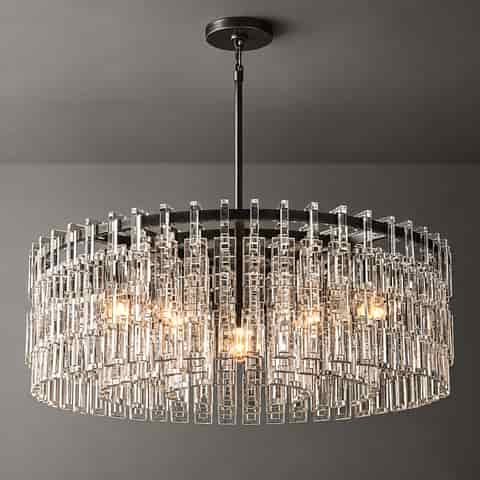 Gold finish drum chandelier with a central light source, clear rectangular accents, and concentric metal rings