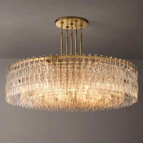 Gold modern drum chandelier with layered rings, multiple suspension rods, and warm glowing bulbs