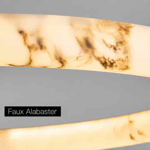 Close up of illuminated faux alabaster texture on a ring LED chandelier