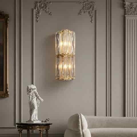 Tall Art Deco glass wall sconce with brass finish in a dark modern bedroom