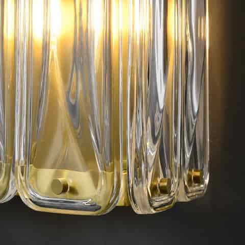 Close up of clear molded glass blocks and brass finish hardware on an Art Deco wall sconce