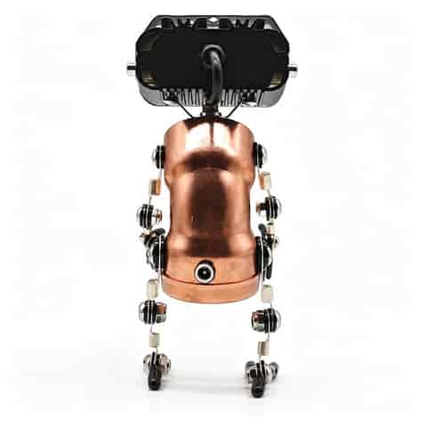 Steampunk robot table lamp with copper tone metal body, articulated legs, black dual lens light head and mechanical joints on a white background