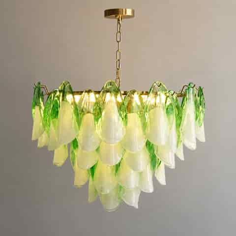 Green and white glass petal chandelier illuminated with warm light