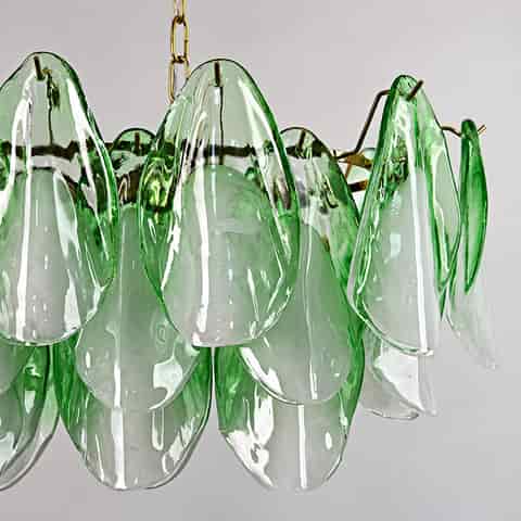 Detailed view of layered green and translucent glass petals on a sculptural chandelier