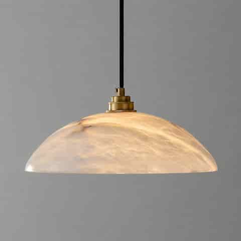 Illuminated natural alabaster dome pendant light with open bottom and warm diffused glow
