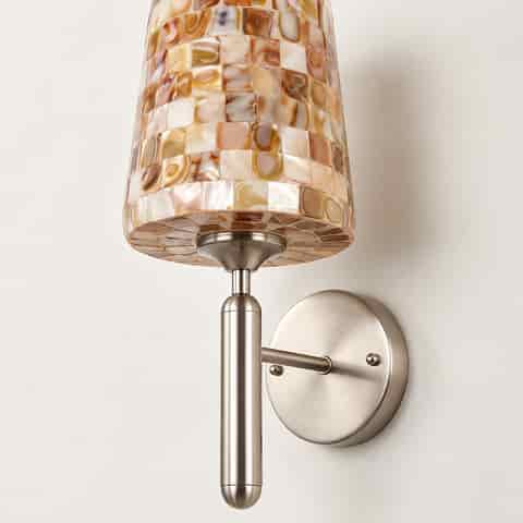 Close up of iridescent mother of pearl mosaic tiles on a decorative wall light shade