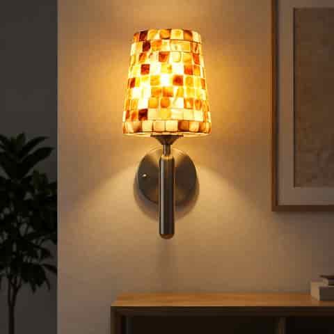 Full view of a decorative mother of pearl mosaic wall sconce on a neutral wall background