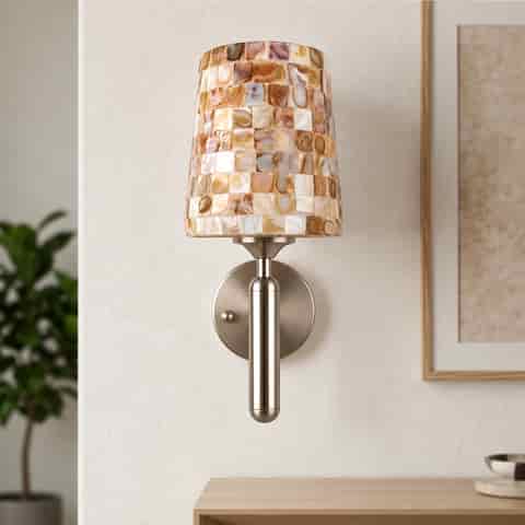 Vertical mother of pearl mosaic wall sconce with a cylindrical brushed nickel metal body and round wall mount