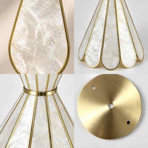 Gold shell wall sconces creating warm ambient lighting in an elegant residential hallway