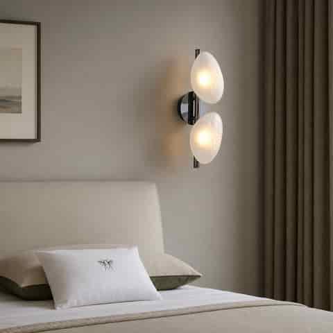 Two light frosted glass wall sconce installed beside a neutral modern bedroom bed