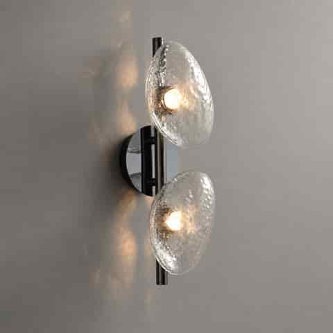Two light modern textured glass wall sconce with organic clear pebble shades and black metal frame