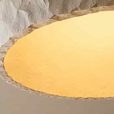 Sculptural Wabi Sabi style flush mount ceiling light showing its irregular hand textured ivory surface and warm illuminated diffuser