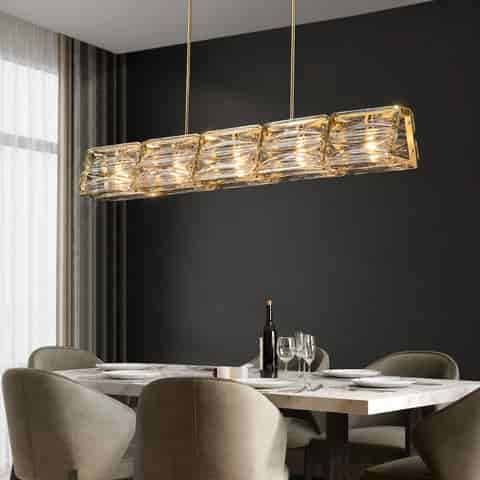 Gold copper and textured glass linear chandelier above a contemporary dining table in a modern home