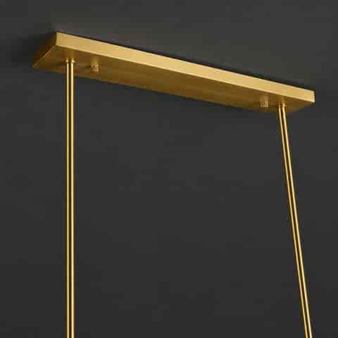 Close up of gold copper linear chandelier canopy and modular suspension rods with refined brushed finish