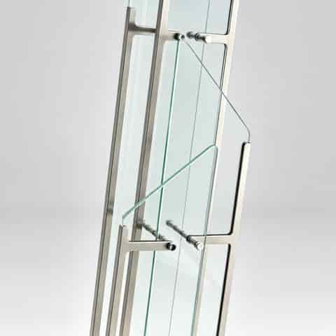 Close up of clear glass panels, gold tone metal frame and detailed connectors on a geometric LED floor lamp