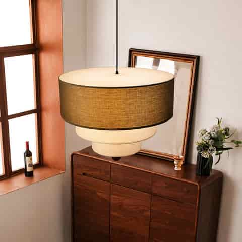 Top view of olive green and cream tiered fabric pendant light showing layered drum construction