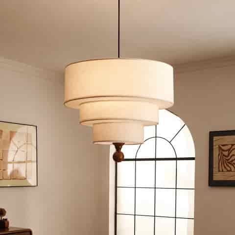 Cream three tier fabric pendant light in a warm mid century modern room with arched window
