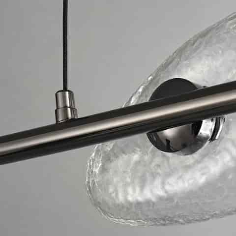 Close up of frosted organic glass shade mounted on a dark metal linear chandelier frame