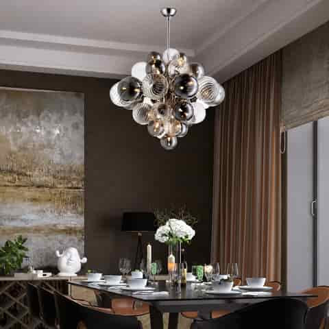 Smoked glass globe cluster chandelier above a contemporary dining table with clear and ribbed glass shades