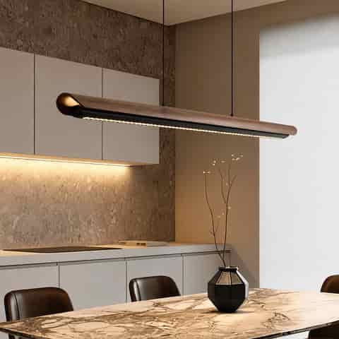 Walnut tone linear LED pendant light above a modern dining table