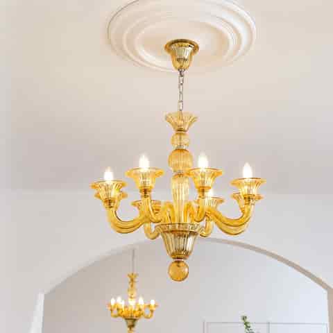Amber glass 8 arm chandelier installed in an elegant interior